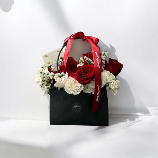 Elegant bouquet of red and white roses in a stylish bag. Same day flower delivery from local florists with free shipping and fresh flower arrangements near me.