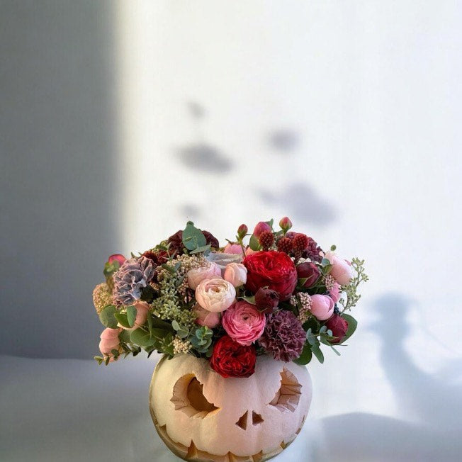 Flower Arrangement in a Pumpkin for Halloween